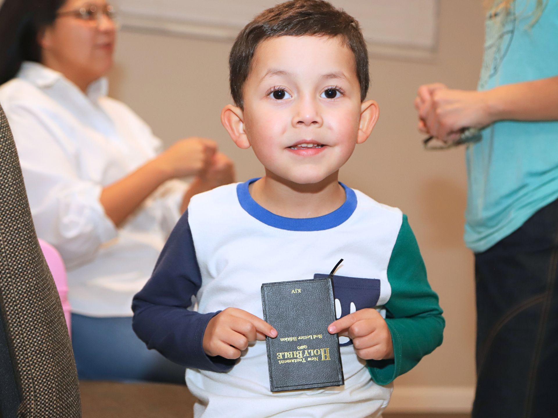 A child holding a Bible in Tampa Kids